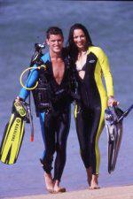 Couple
          scuba diving on the beach